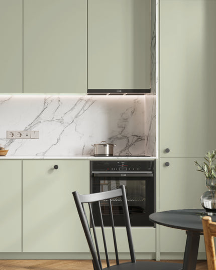 Mattgrüne IKEA Metod Küchenfronten in moderner Küche mit Marmorwand und schwarzem Ofen. - NovaFronten - Küchen Fronten Konfigurator - Standard - Matt